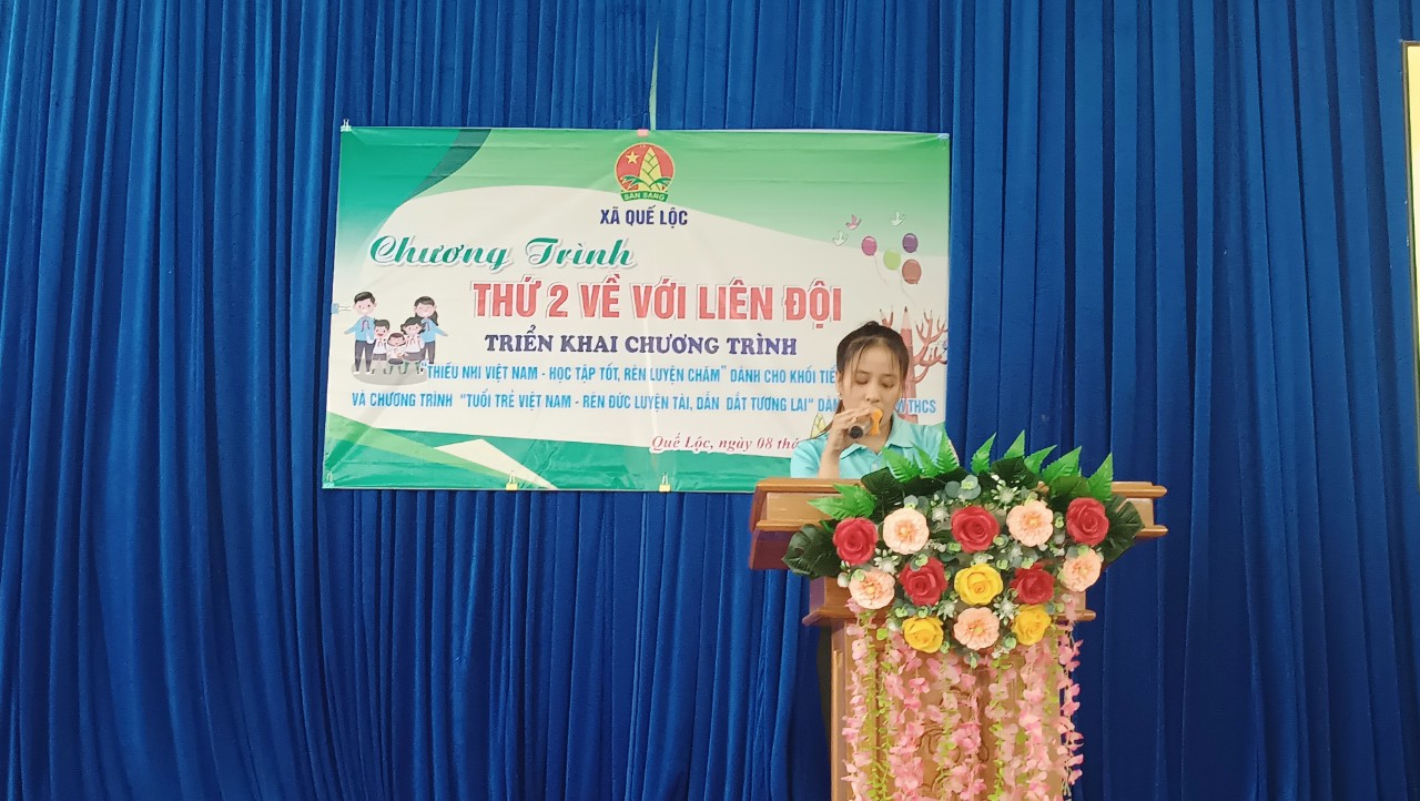 A child standing at a podium with a banner

Description automatically generated