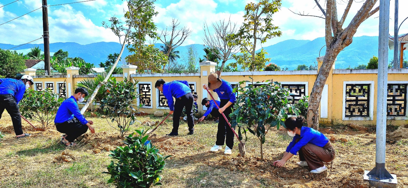 A group of people working in a garden Description automatically generated