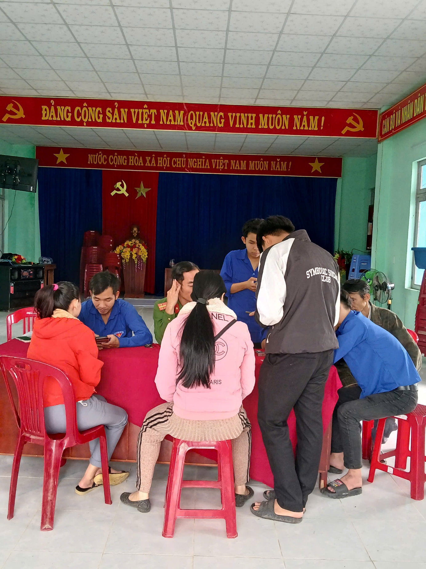 A group of people sitting around a table
Description automatically generated