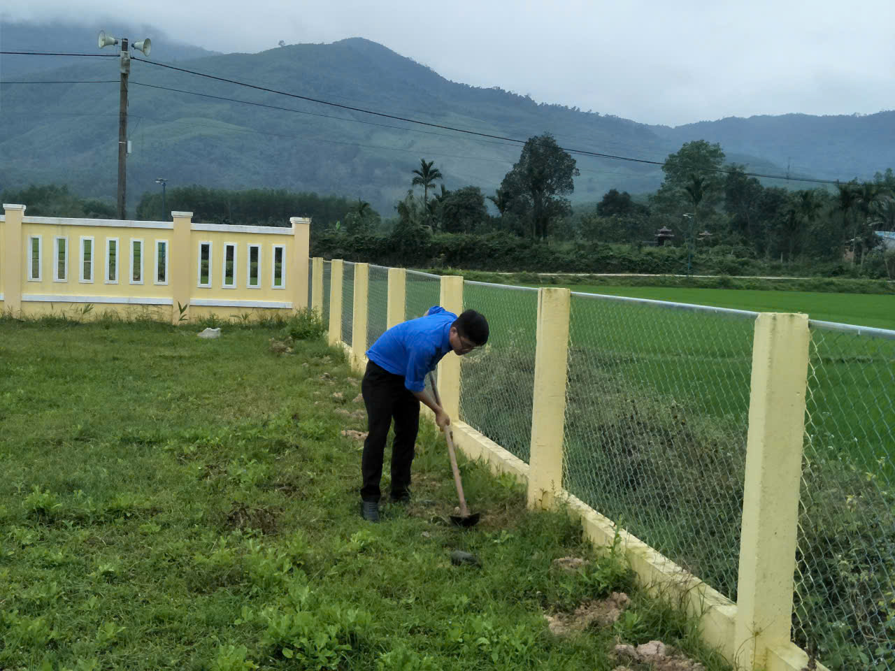 A person digging in the grass
Description automatically generated