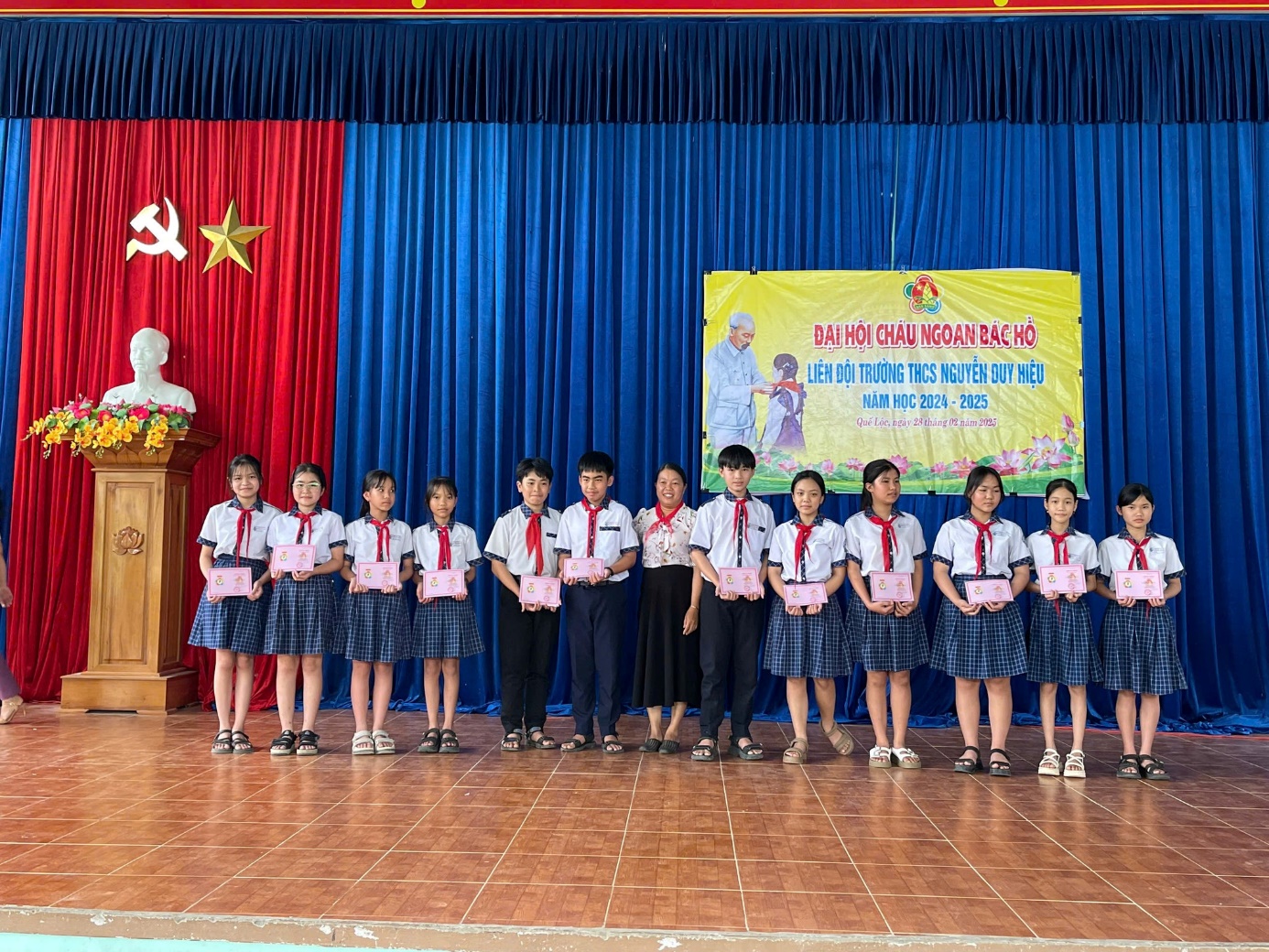 A group of children on a stage Description automatically generated