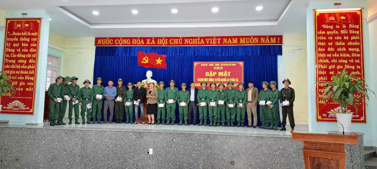 A group of people in uniform standing on a stage
Description automatically generated