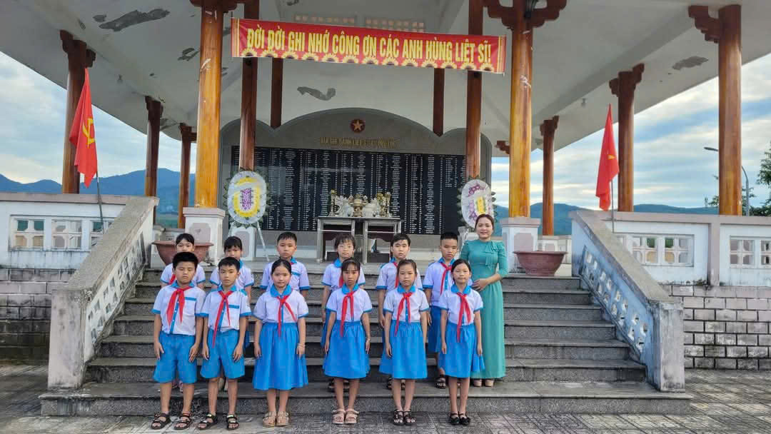 A group of children in blue uniforms standing on stairs
Description automatically generated