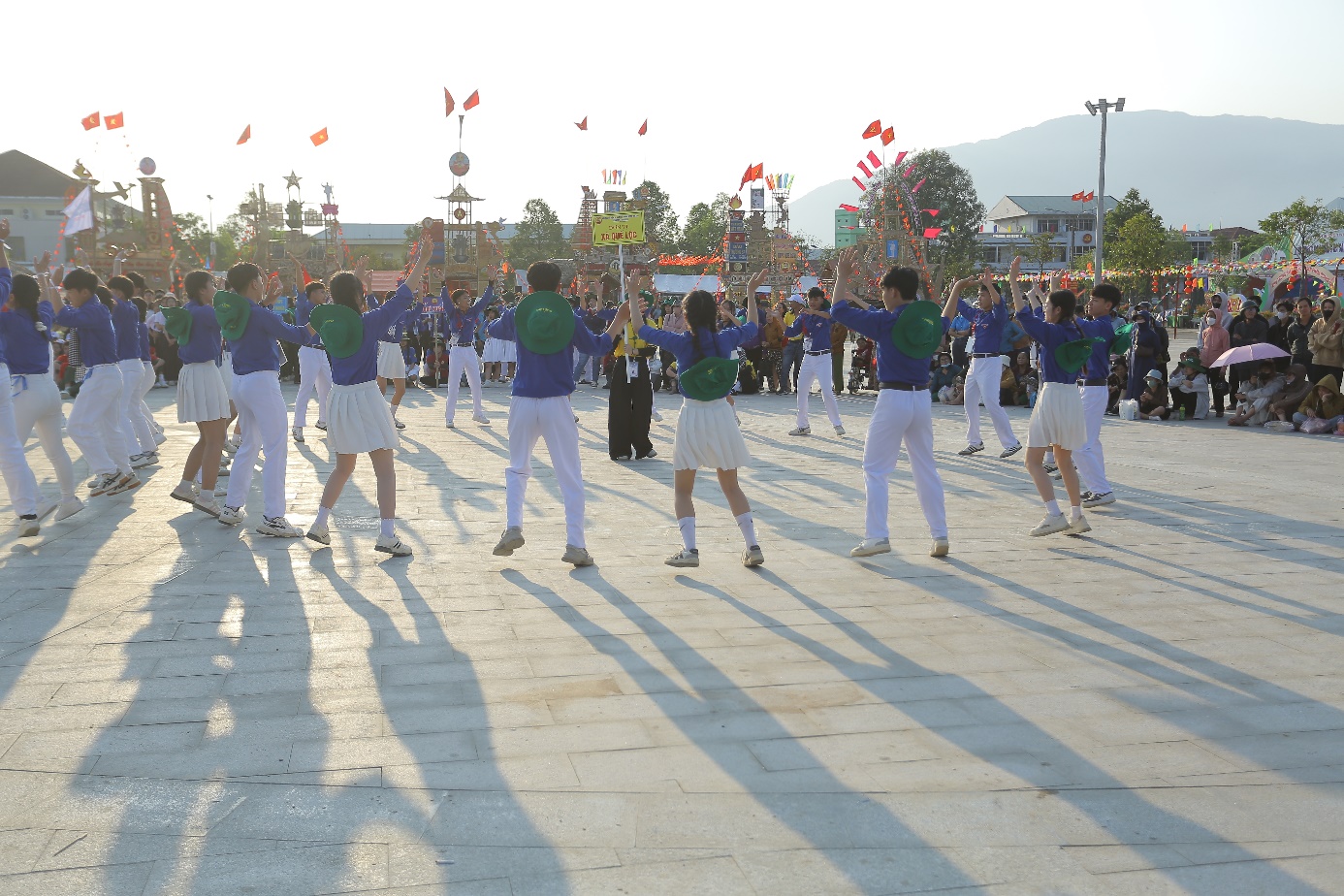 A group of people dancing in a parade Description automatically generated