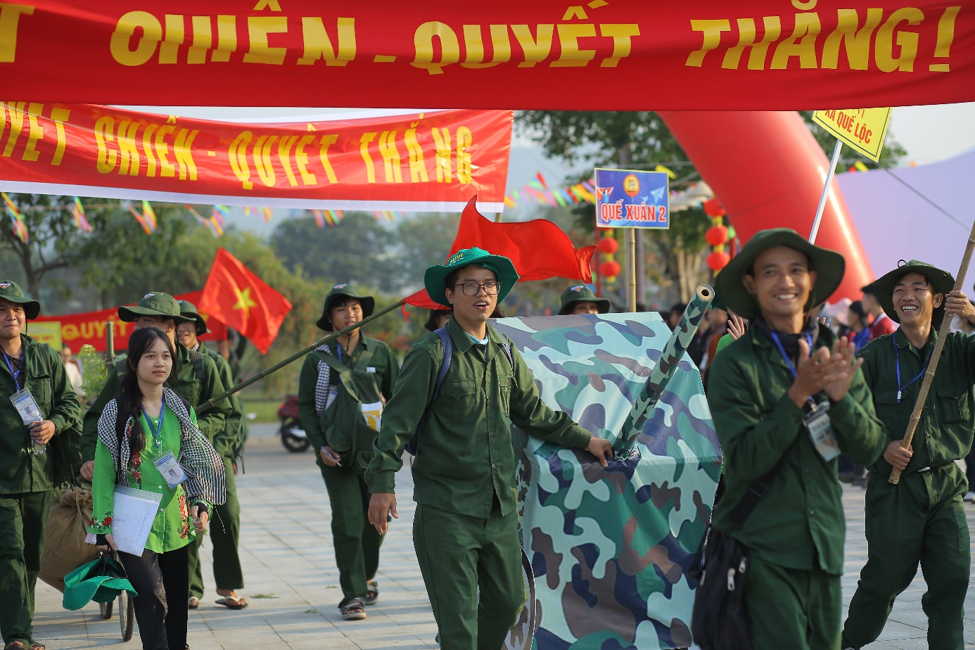 A group of people in green uniforms Description automatically generated